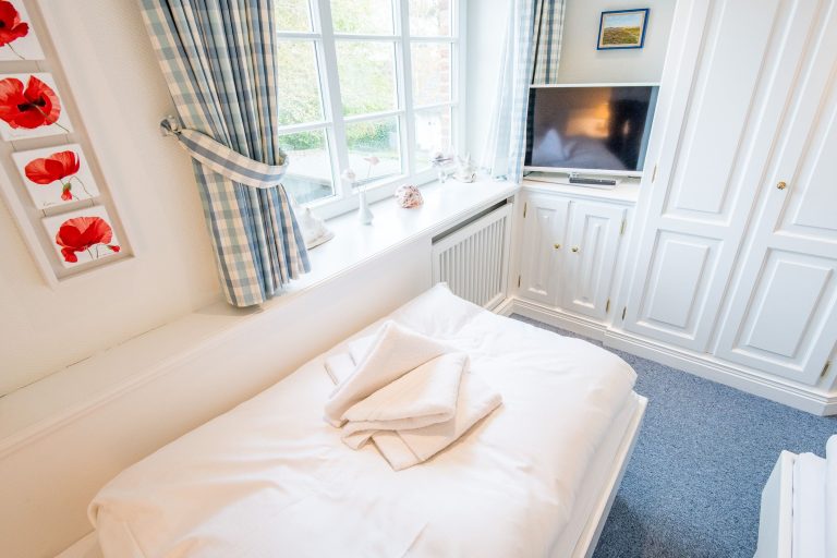 Schlafzimmer mit Fernseher in Ferienhaus auf Sylt