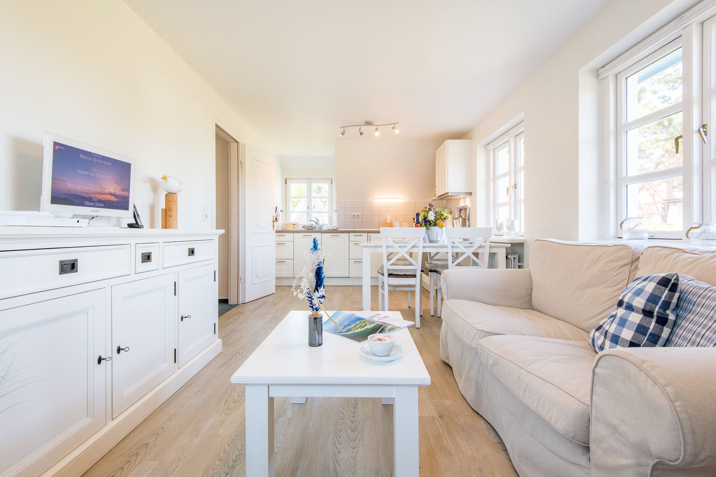 Sofa und offene Küche in Ferienhaus auf Sylt