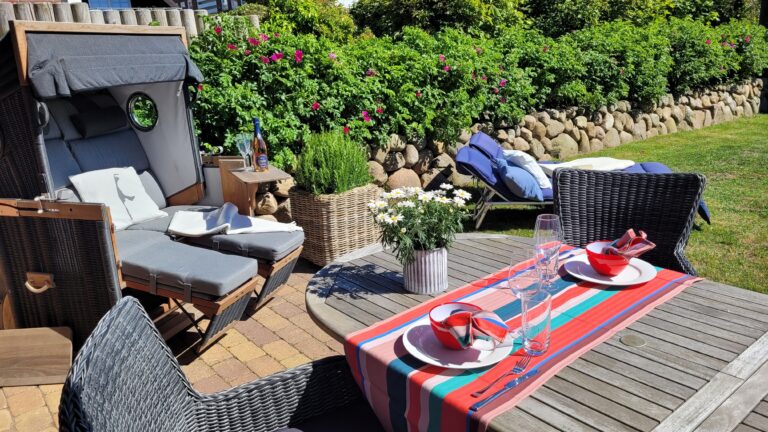 Terrasse mit Strandkorb und Rasen in Ferienhaus auf Sylt